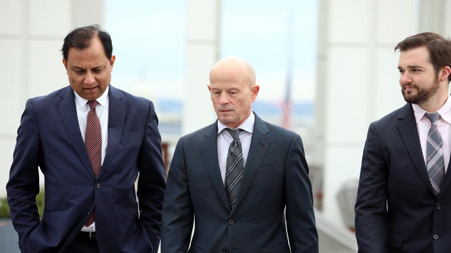 Men employees from IGI walking and talking